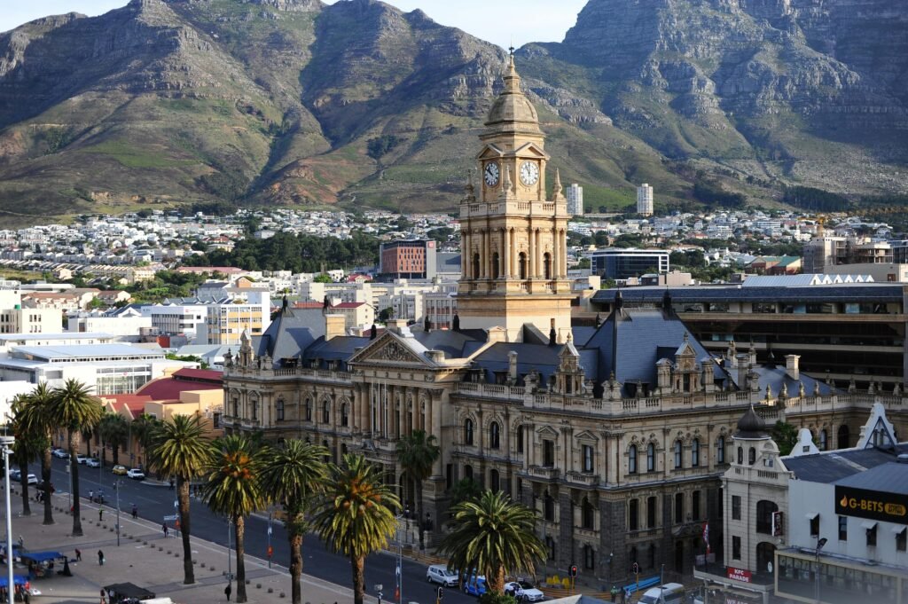 Stunning aerial view of Cape Town City Hall against Table Mountain backdrop in South Africa.